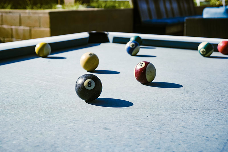 closeup of pool balls on outdoor pool table